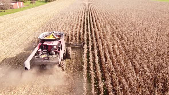 Combine Harvester At Work Gathering Corn In The Field, Southeast Michigan - aerial drone shot alt
