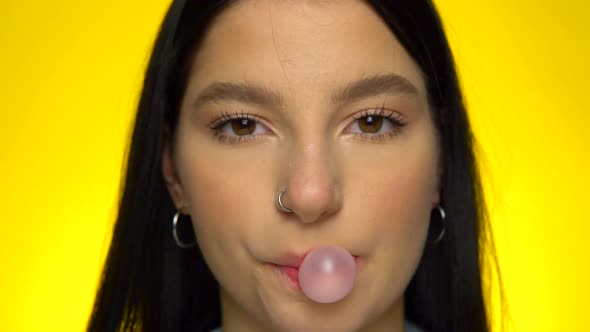 Woman Blowing Bubble Gum Face Close Up To Camera Slow Motion Eating Candy