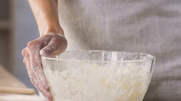 Female Culinary Putting Eggs Into Bowl with Flour Preparing Dough Slow Motion alt