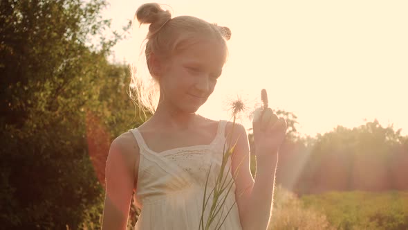 Child Girl Playing With The Dandelion Flower  alt