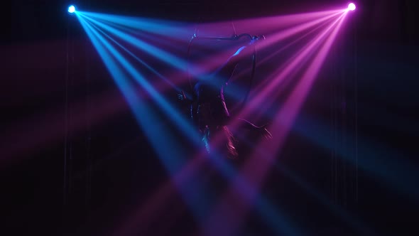 Young Adult Woman Using Aerial Hoop, Making Flexibility Twine Exercise in Air. An Aerialist Is alt