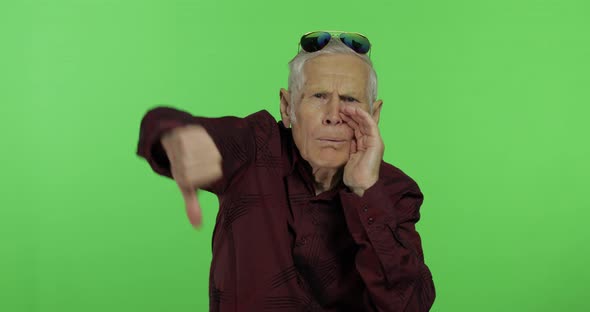 Senior Man Something Giving Thumb Down. Handsome Old Man Showing Displeasure alt