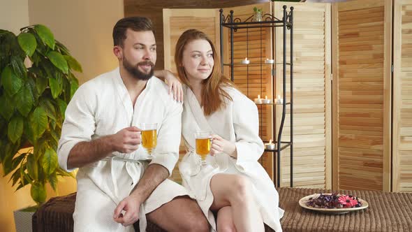 Relaxed Man and Woman Enjoying Tasty Tea After Spa Procedures