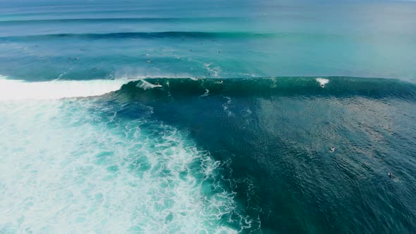 Aerial View of Surfers on Their Board Catching the Waves alt