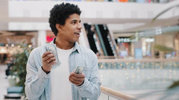 Happy African Successful Business Man Counting Money Standing Indoors alt