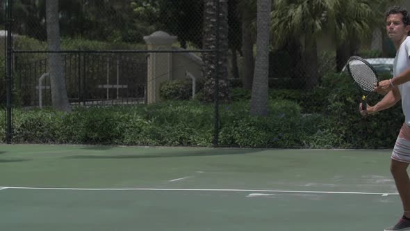 A young man playing tennis with his girlfriend. alt
