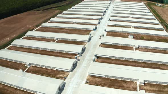 White buildings of manufacturing on the field alt