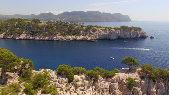 Aerial travel drone view of clear green water, cliffs of Cassis, Mediterranean Sea, Southern France. alt