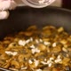 Cooking food concept. Cook fry the mushrooms in a frying pan. Slowmotion close up of chef mixing mus - VideoHive Item for Sale