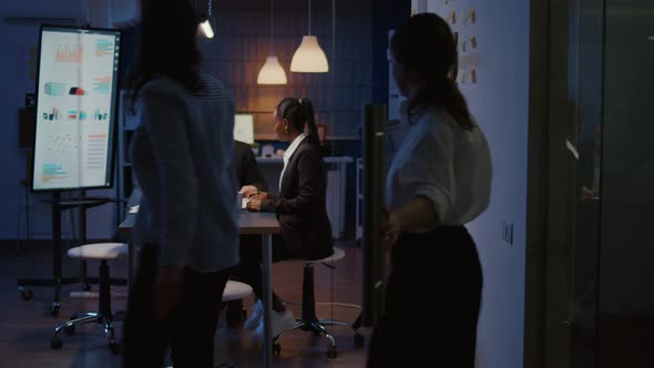 Multi Ethnic Business Team Sitting at Conference Table in Office Meeting Room Checking Financial alt