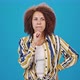 African American Woman Thinks Standing on Blue Background - VideoHive Item for Sale