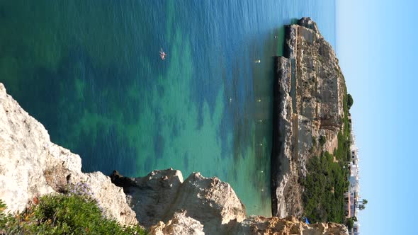 Vertical video of the kayaks, coastal cliffs and tropical waters of Benagil alt