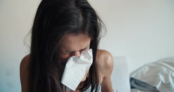 Sickly Female Blows Her Nose Into a Disposable Napkin in Season of Colds alt