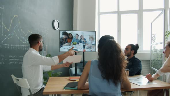 Multiracial Business Team Talking to Colleagues Online Through Video Call Discussing Project at Work alt