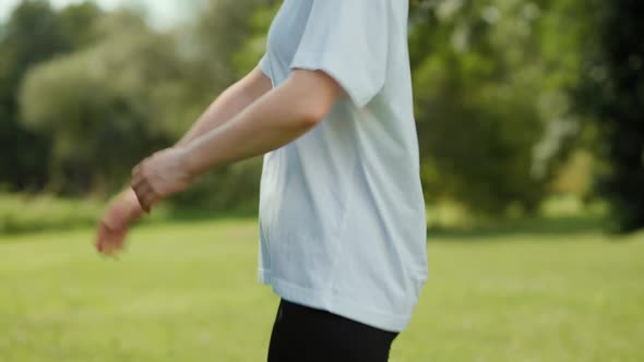 A young fit smiling woman in sports clothes doing exercise. alt