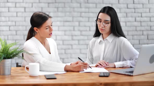 Confident Business Female Discussing Project Making Notes on Paper alt