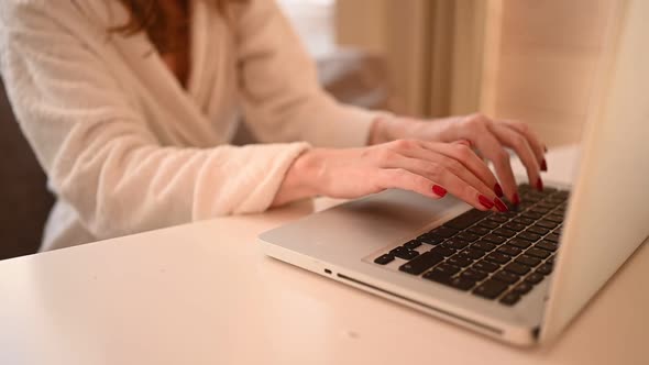 Technology Concept Close Up Young Woman Hands Working Online with Laptop Computer in White Bathrobe