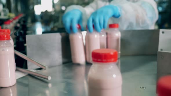 Bottles with Yogurt Moving on a Line at a Cheese Factory. Food Packaging, Food Factory Conveyor alt