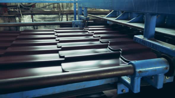 Metal Tile Is Getting Cut By the Factory Conveyor alt