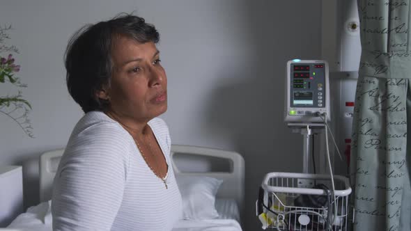 Worried woman sitting on hospital bed 4k alt