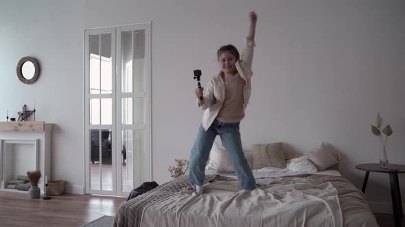 Girl Child Blogger Broadcasts Live Online and Writes Blog on Bed Closeup