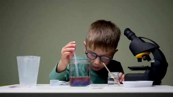 Alternative Education. Kid Doing experiments.Leisure Activity Indoors. Child Playing with Reagents