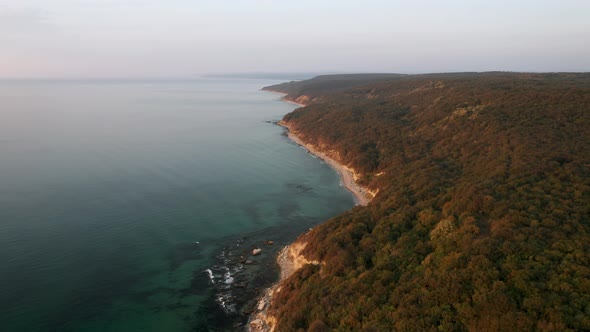 Drone flight above a picturesque rocky coastline alt