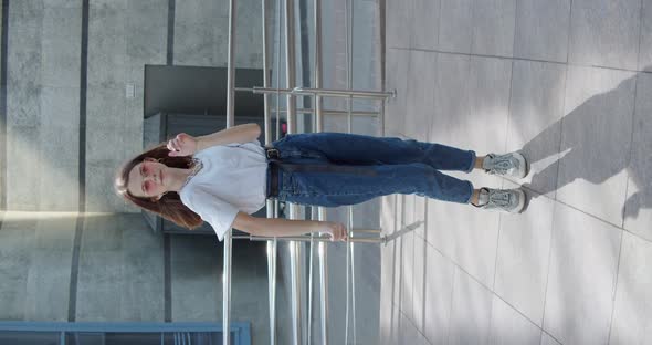 Carefree Girl in Stylish Look and Glasses Dancing and Having Joy Front Camera alt