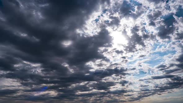 Dramatic Cumulus Cirrus Clouds Move in the Blue Sky. Sunbeams Shine. Time Lapse alt