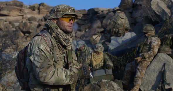 Soldiers Taking a Break From Patrol alt