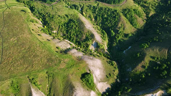 Drone View of Hills Fields and Chalk Mountains in Sunny Weather alt