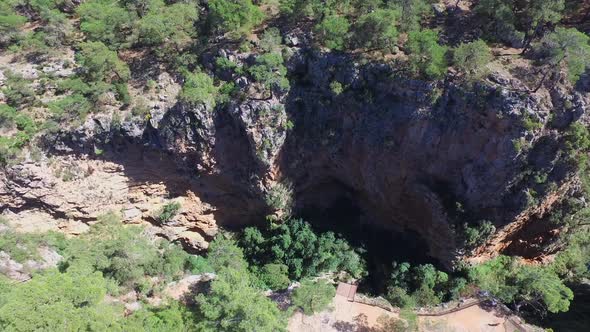 Turquoise Blue Stream Waters at Base of Deep and Steep Rocky Canyon alt