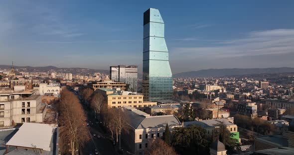 Flying over Shota Rustaveli street in the center of city. Morning aerial cityscape of Tbilisi alt