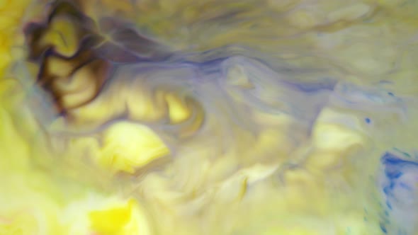 Ink in Water. Yellow and Violet Ink Reacting in Water Creating Abstract Background.