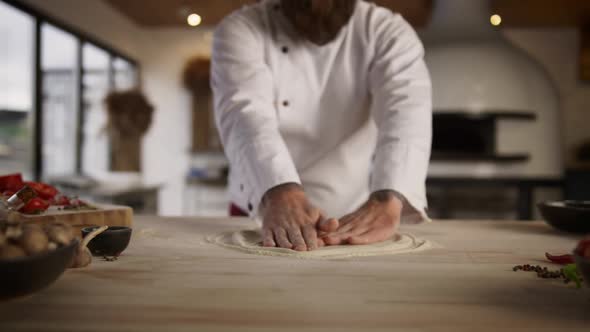 Culinary Chef Cooking Pizza Dough in Restaurant Kitchen alt