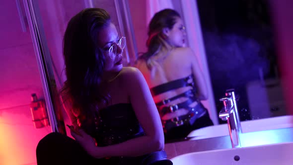 Drunk Sexy Woman Dressed Bdsm Leather Lingerie is Leaning on Wall in Restroom Medium Portrait alt