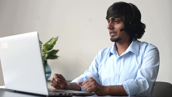 Closeup Portrait of Indian Male Support Worker Wearing Wireless Headset alt