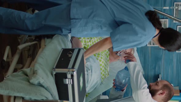 Vertical Video Doctor and Nurse Using Oxygen Tube for Resuscitation alt