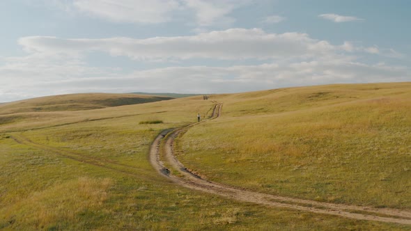 Man is walking along an abandoned path Summer Baikal lake Olkhon island alt