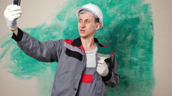 Advanced Repair Blogger in Workwear Shoots Video By Wall alt