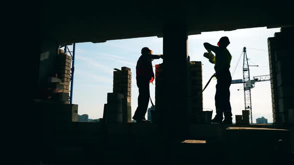Construction of the Brick Wall Held By Male Engineers alt