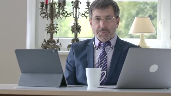 Elegant Caucasian Man in Suit and Necktie Waving Goodbye at Camera and Standing Up alt