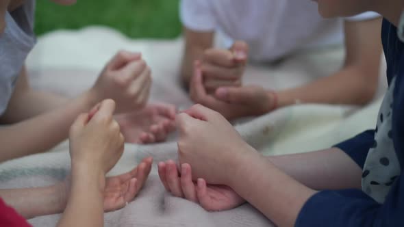Caucasian Children Playing Rock Paper Scissors Gesturing in Slow Motion Outdoors alt