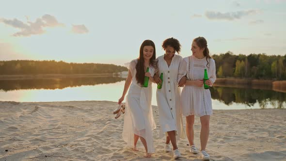 Group of Female Friends Having Fun on a Lake Beach at the Party