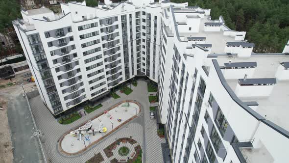 Aerial View of a Newly Modern MultiStorey Building in a Forest Area alt