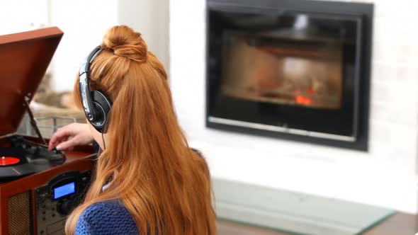 Beautiful woman listening music on turntable  alt