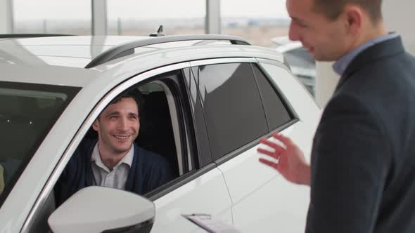 Automobile Show Sales Manager Shaking Hands Male Customer in Auto Inside Buyer is Choosing