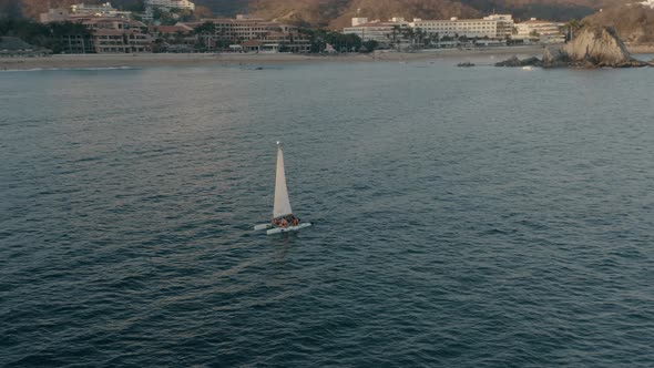 Touristic boat near coastline on sunset
