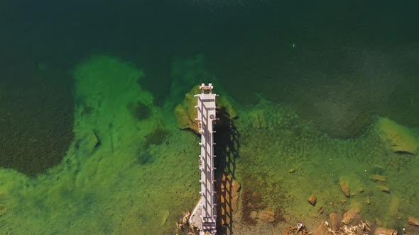 Aerial Top View of Wooden Little Bridge in Mountain Lake in Autumn alt