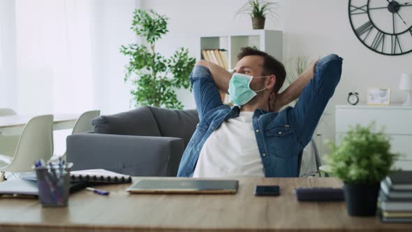 Zoom out video of satisfied man working at home. Shot with RED helium camera in 8K. alt